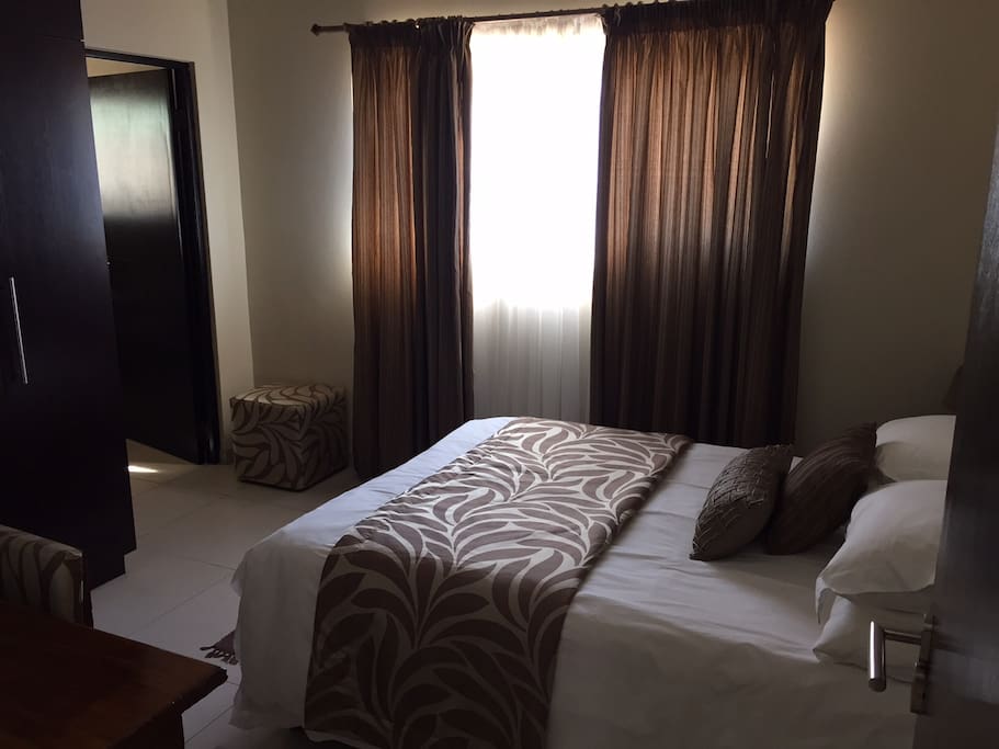 Double bed with linen to match the season, writing desk