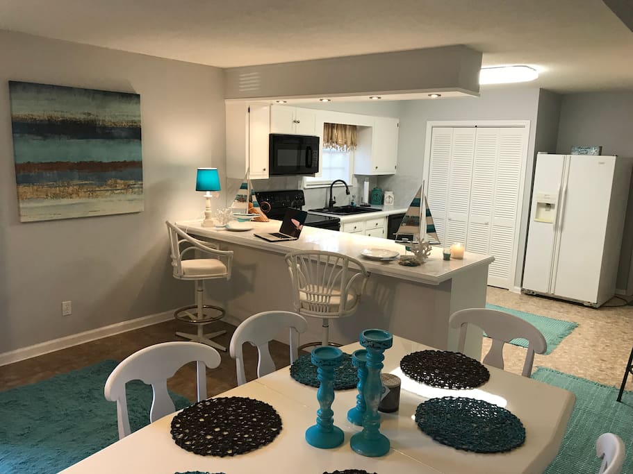Living room opens into this dining area and open kitchen.