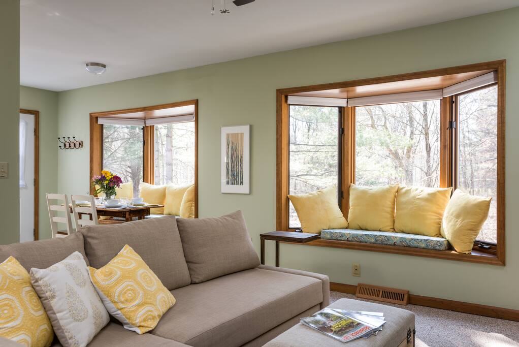 Nicole: "Both the bed and pull out sofa were extremely comfortable with high end bedding." Bright, comfortable, living room with a couch that turns into a full size bed.