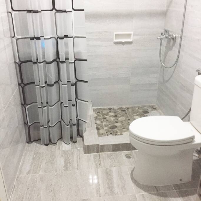 Newly renovated bathroom with hot shower and washing machine