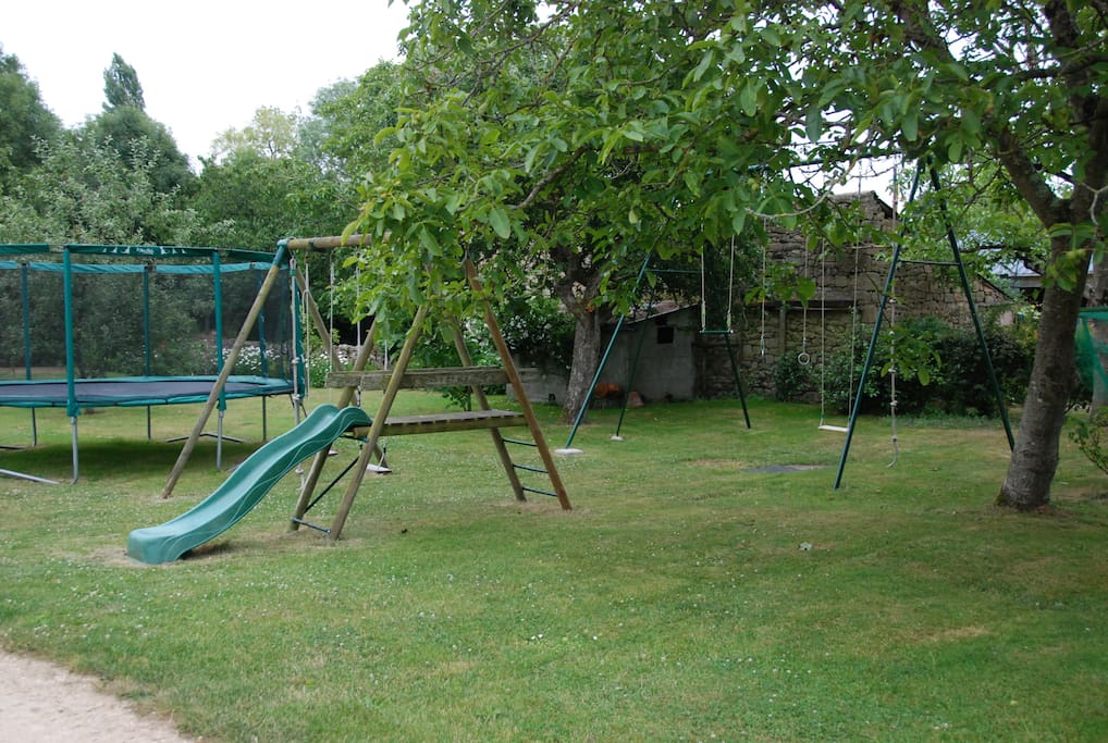 jardin avec balançoire, toboggan et trampoline