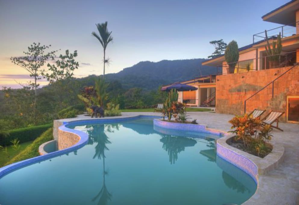 Infinity pool with outdoor shower and private bathroom.