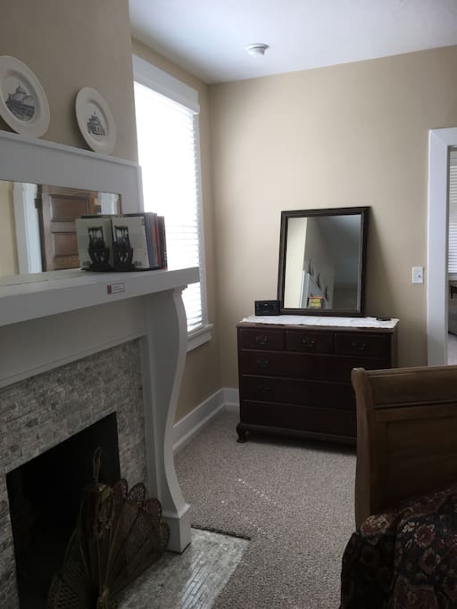 A restored, original decorative fireplace adds charm to the bedroom.