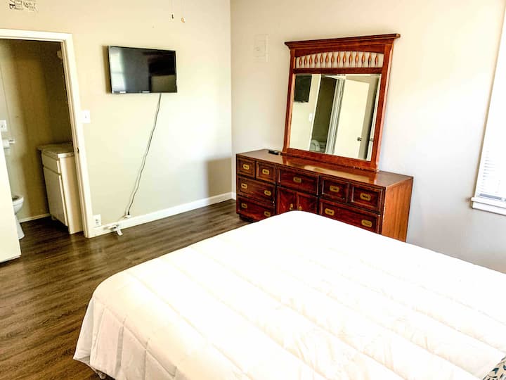 Master bedroom from another angle showing half bathroom.