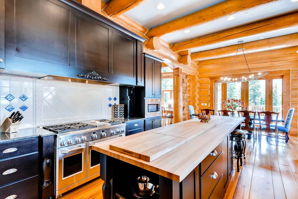featuring six-burner gas stove, two ovens, grantie counter tops and large butcher block island with seating