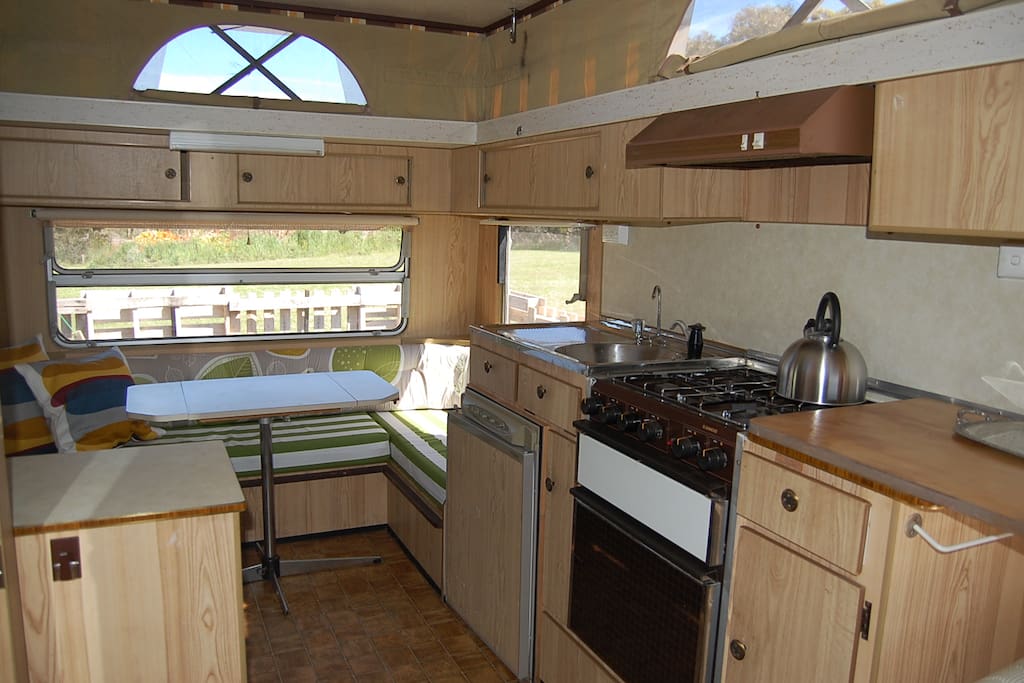 Dinette, kitchen with 4 burner stove, grill, oven and fridge.