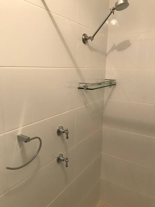 The totally new bathroom with all those quality creature comforts:
Glass platform for holding gels, soap etc; hand towel holder, towel holder, toilet paper holder, and quaint vanity housing extra supplies of bathroom necessities. There’s also a hook on the curtain rail to hold your toilet bag for easy access of personal products.