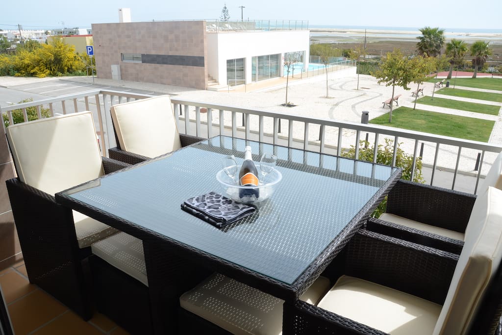 Dining on the balcony with pool and sea views
