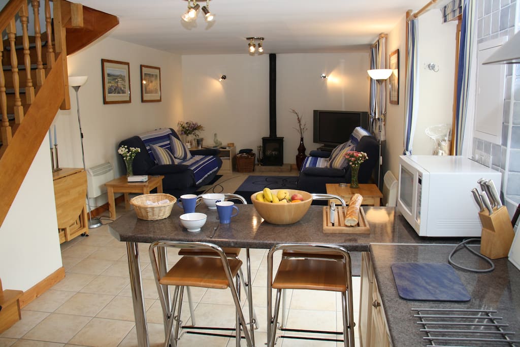 Ground floor has living area with gate leg dining table, kitchen & bathroom