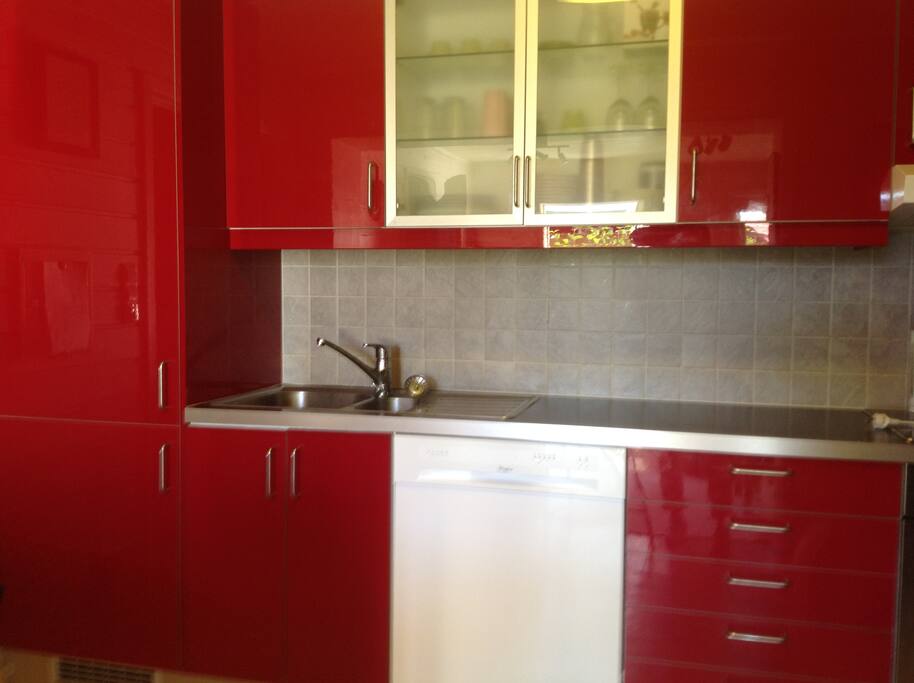the kitchen has refrigerator, freezer, washing machine, plates cups etc. spacy!