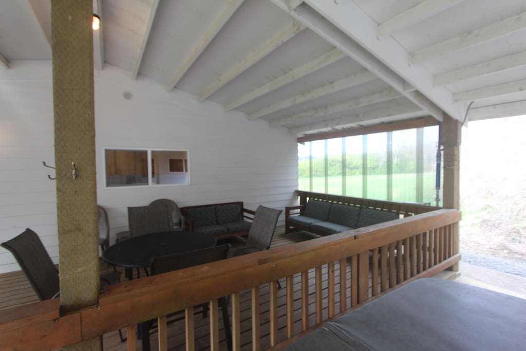 Covered patio with lots of seating and BBQ