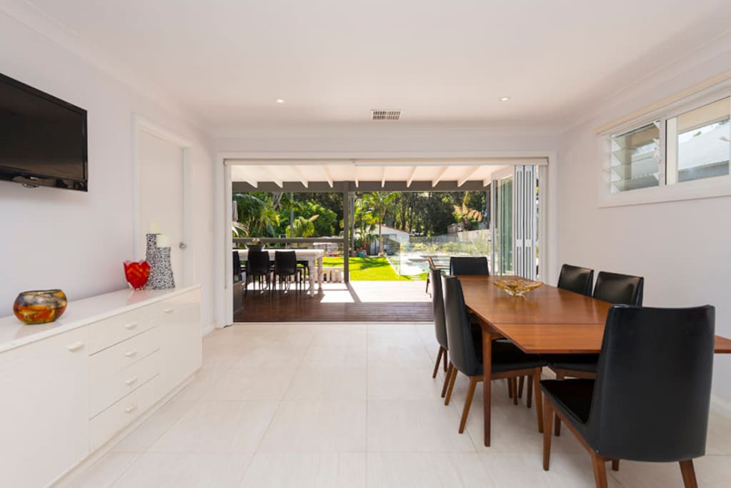Dining room with bi fold doors opening to yard