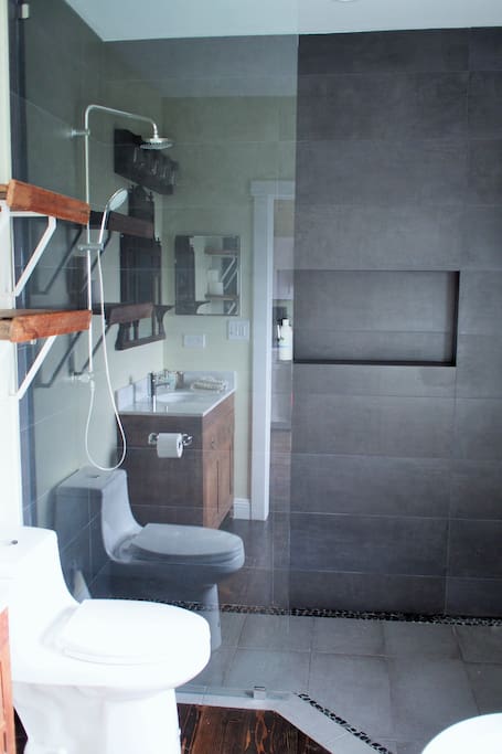 bathroom with walk-in shower, soaking tub