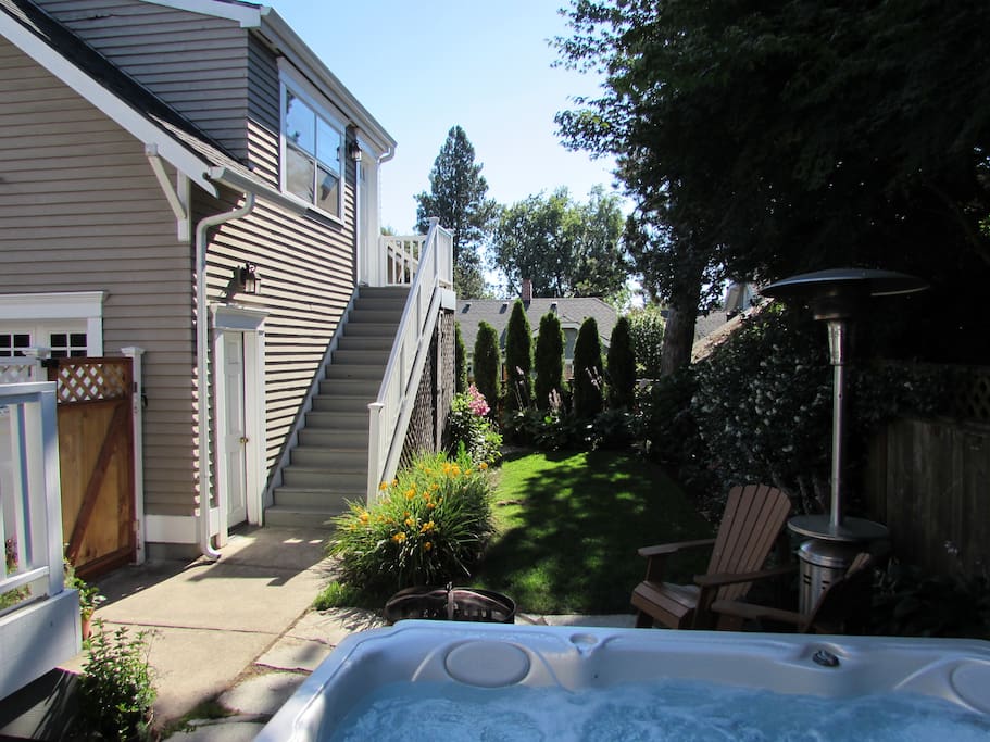 Relax in the shared backyard with hot tub, sitting area and fire pit.