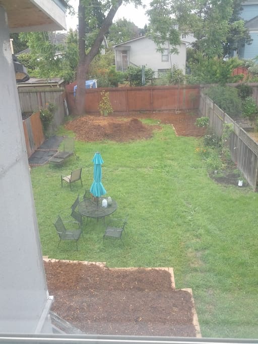 Huge yard with patio furniture, bbq, and veggie garden. We are converting the yard to low water.
