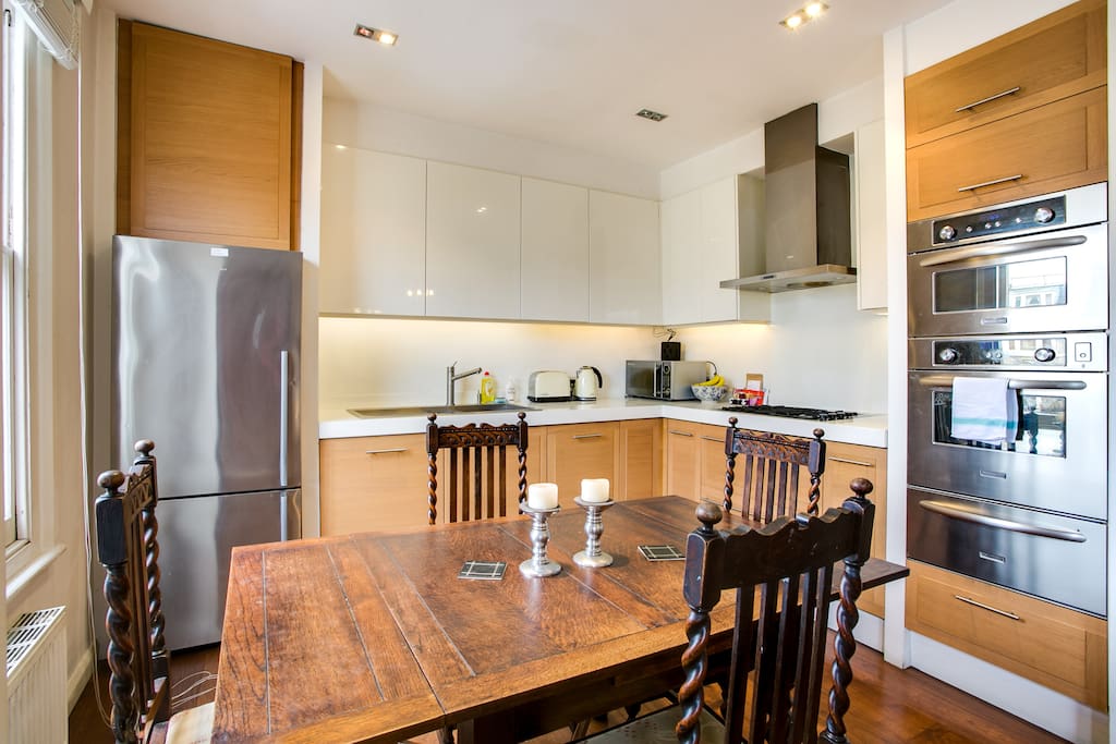 A fully-equipped kitchen with a dining table...