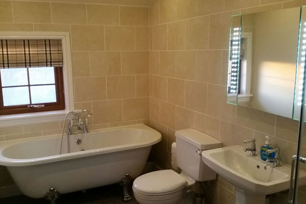 Roll top bath with shower to the right of photo.