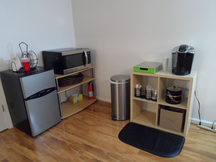 Mini frig with freezer, microwave, Keurig coffee maker, coffee, utensils, etc