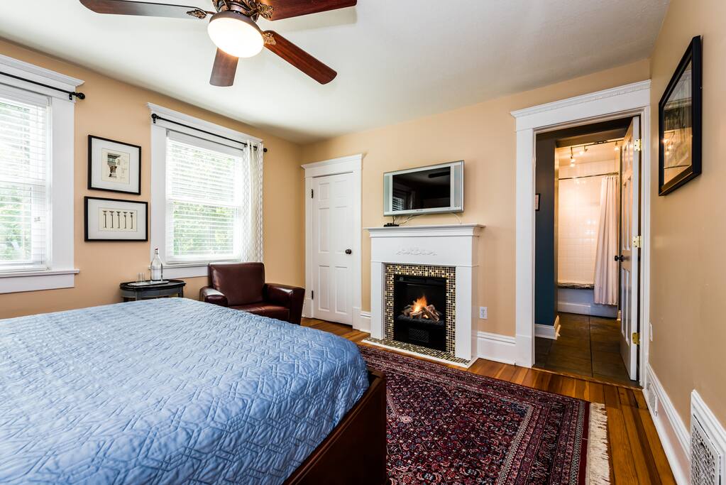 LCD TV with expanded cable, glass-tiled hearth, leather club chair, walk-in closet, ceiling fan and fine appointments.