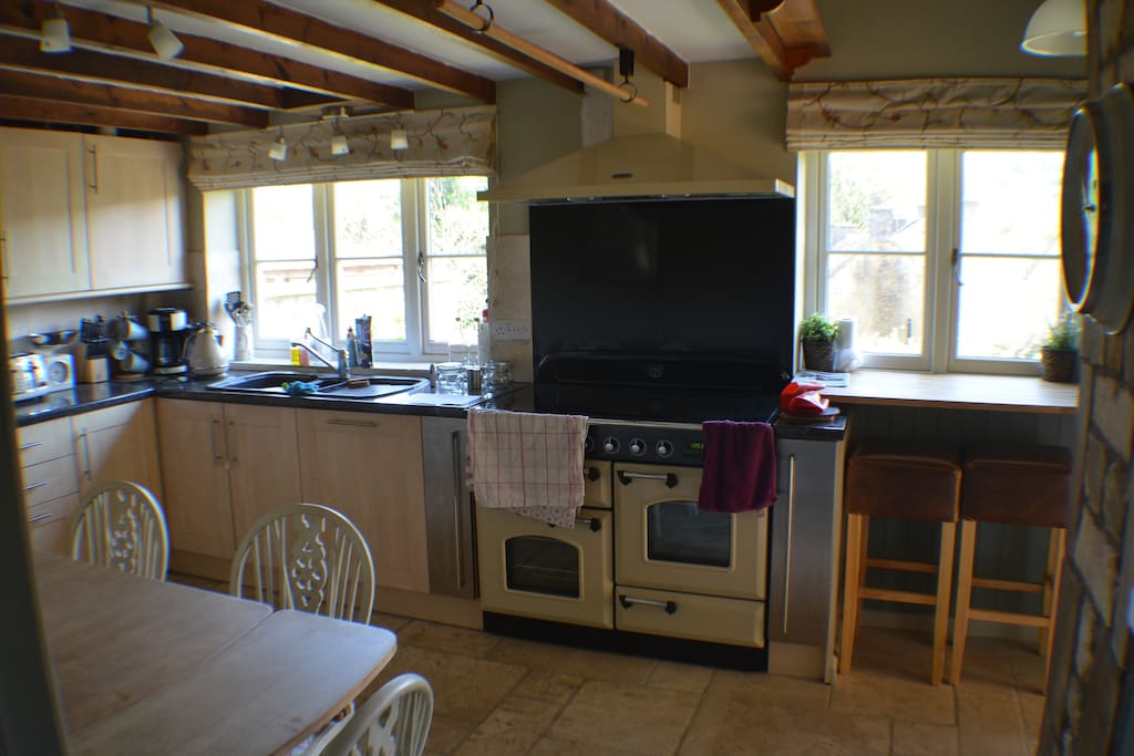 Kitchen with large brand new RangeMaster induction oven. The oven has 5 rings on the hob, two ovens , a warming oven for plates and a storage drawer for backing trays.
