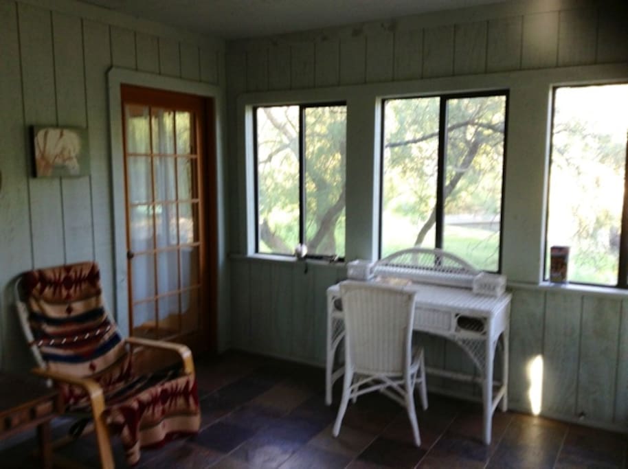 A screened porch gives a tranquil view of the 1/2 acre pond.