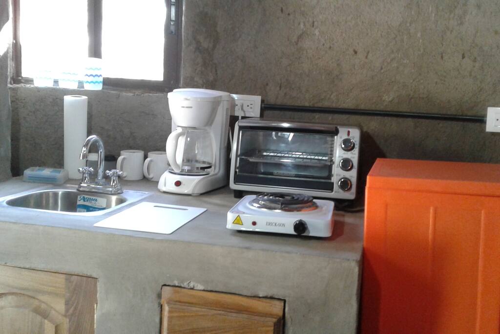 Air conditioning,Coffee pot, toaster oven, hot plate, potable water, cooking and eating utensils provided, refrigerator, and use of outside oven and barbecue.