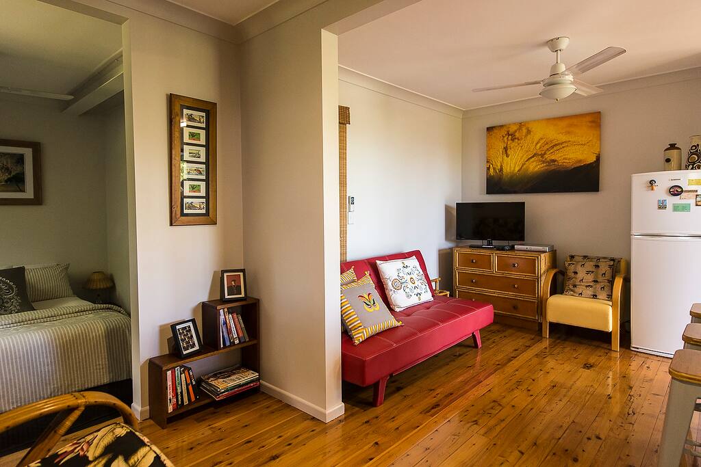 View on entering; Red click-clack sofa bed for that extra person.