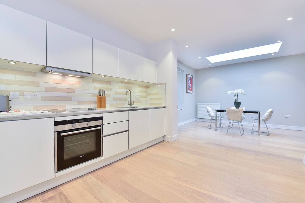 The kitchen is equipped with a fridge freezer, oven, hobs, toaster, kettle and dishwasher. The dining table is positioned close enough to easily serve a meal, but leaves the chef(s) all the room they need to create it!