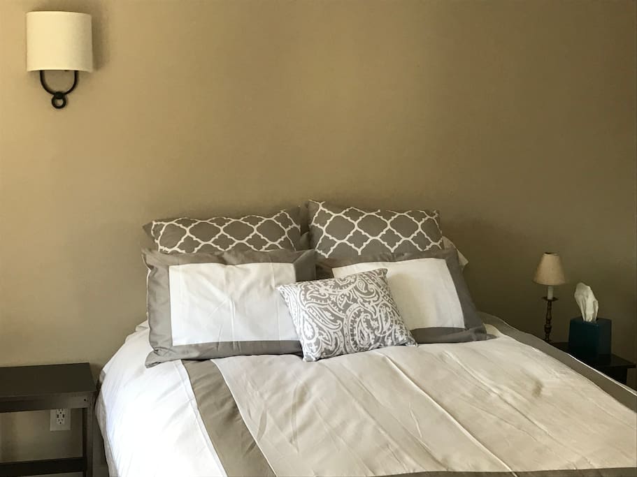 New queen-sized bed with luxury bedding