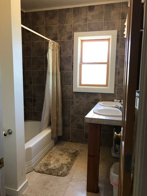 Full size Bathroom with bath tub and 2 sinks.