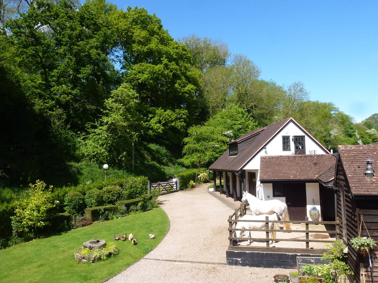 Access from the road; the apartment is above the garages. The entrance door to the apartment can just be seen above the stable.