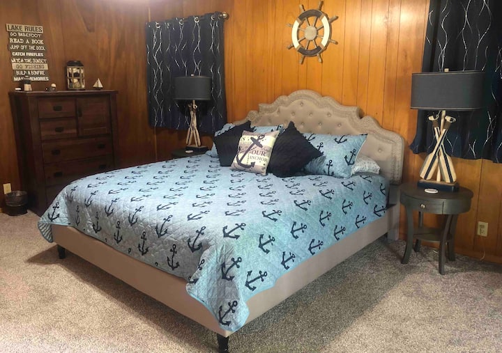 King size bed in bedroom with sliding glass doors out to balcony. Twin size roll-away bed stored in closet, for use anywhere on the main level. 