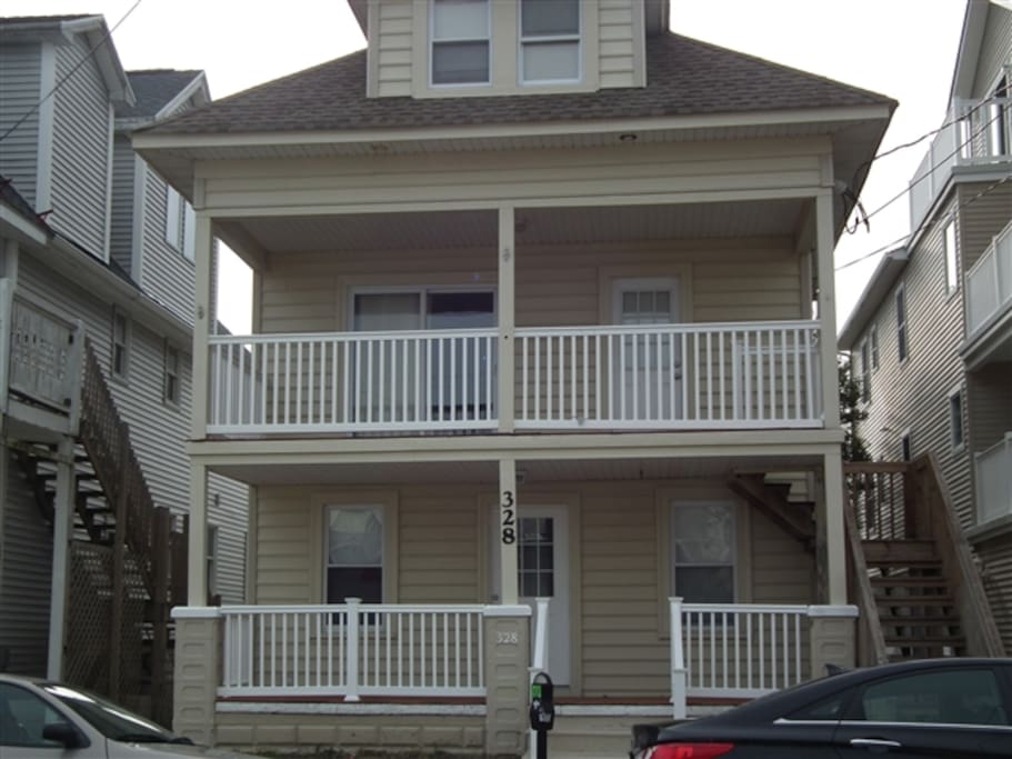 Nice front porch with table and chair set to seat six.