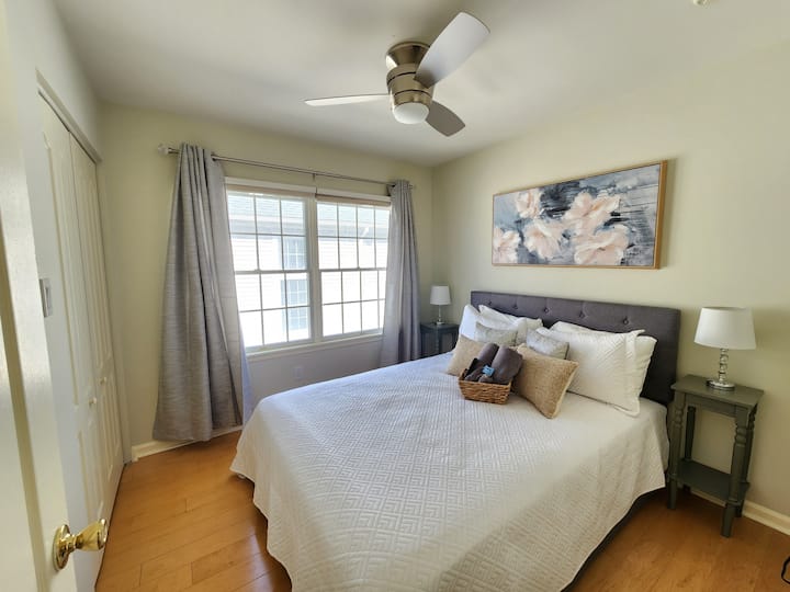Bedroom 2 with a full size bed with storage, closet, ceiling fan and TV