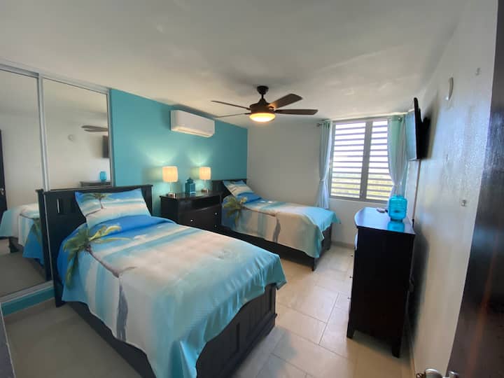 Vibrant beach themed bedroom with twin beds 