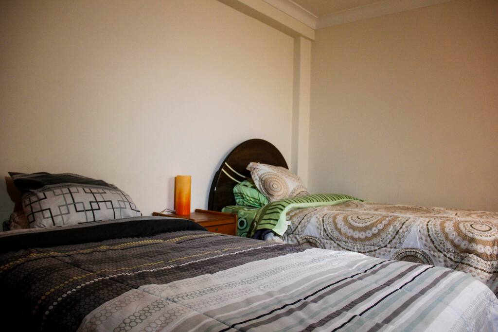 Two beds with night table and lamp