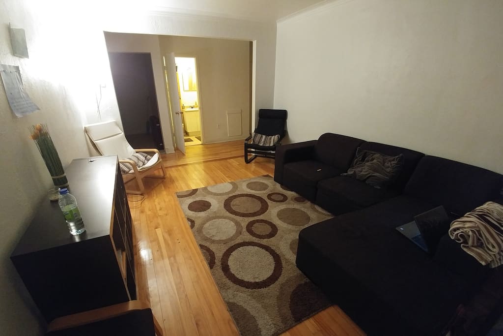 Couch and floor mattress are available in this living room for sleeping.