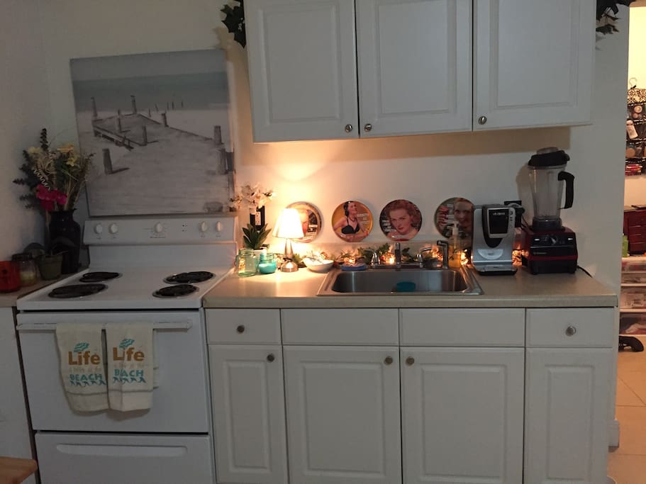 Full size kitchen with microwave, toaster, and coffee maker.