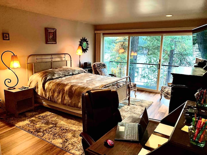 Queen bed with antique desk (color photo printer, copier, scanner, office supplies) leather office chair, two armchairs, ottoman, private deck, walk in closet, 4K 55" Smart TV and view of lake and Kidd Island