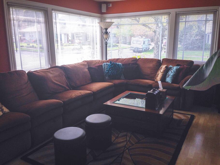 The house is on a corner lot with views to Columbia park one block away - these large windows become snow globes during fall and winter with falling leaves and snow flurries. There is also a bar, flatscreen tv with surround sound and gas fireplace to the right of this photo - picture taken from the large open kitchen - great for entertaining!