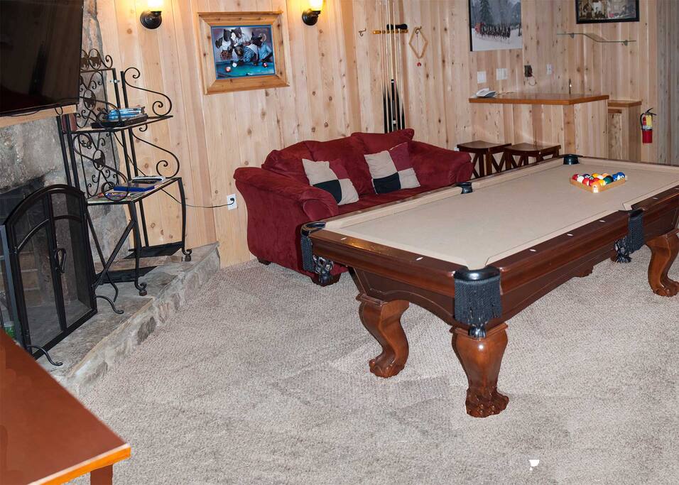 Game room wood burning fireplace, bar, pool table