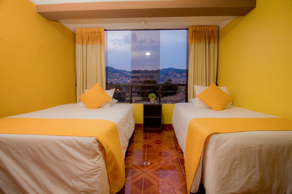 Twin bedroom with city and mountains view