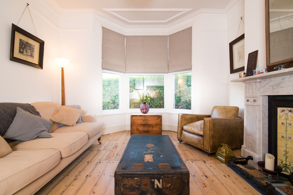 Comfortable sitting room, with traditional furniture and features.