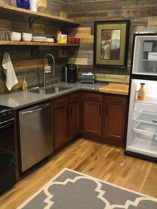 Fully functioning kitchen including dishes, pots and pans and utensils.