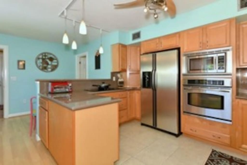 Large kitchen with breakfast bar and extra stools for gathering.