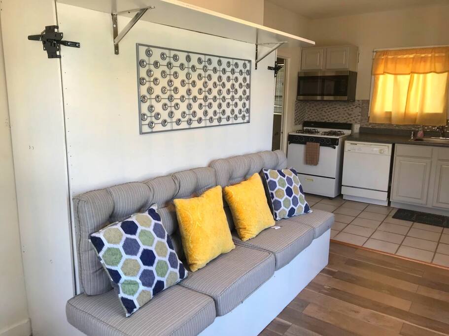 The sofa opens up to a full size queen bed that is mounted to the wall