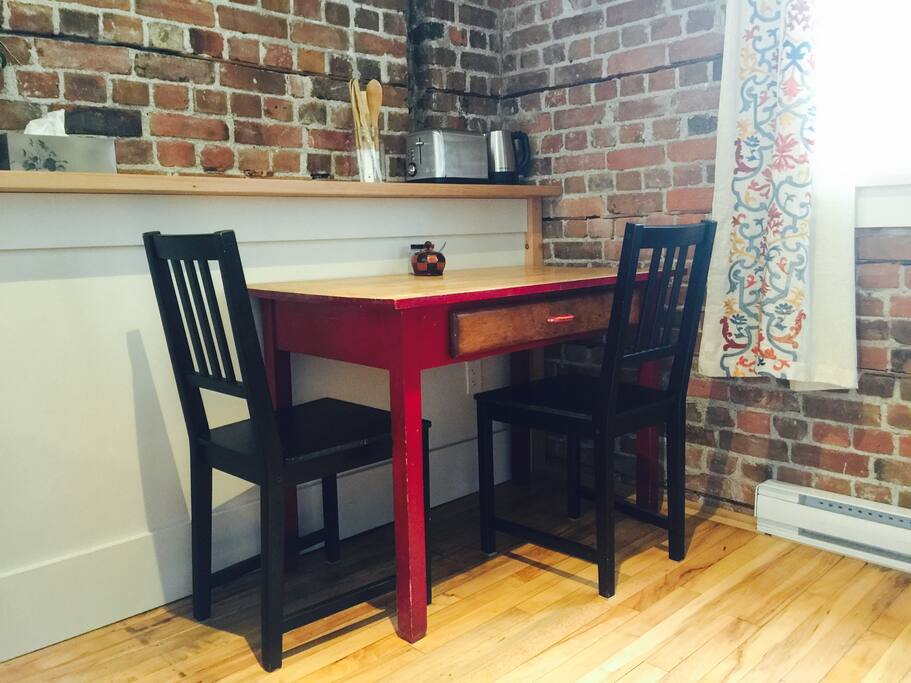 Room for two at the cozy red schooldesk-turned-table.