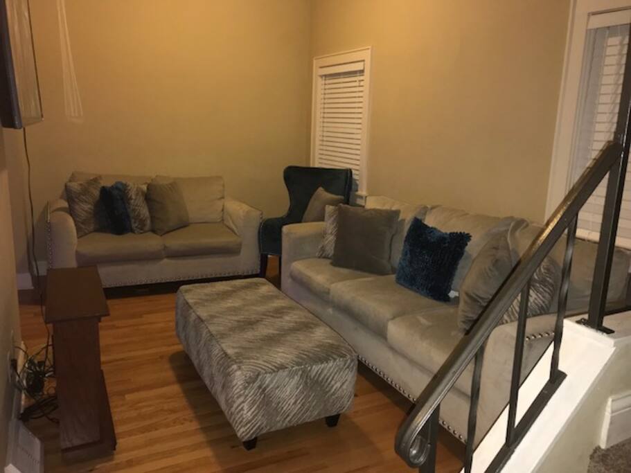 Living Room, 2 Couches, Chair, Ottoman, Flat Screen Smart TV & Fireplace