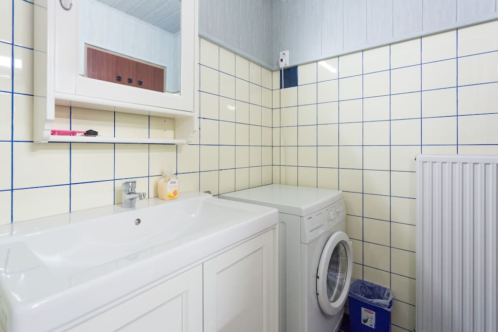 Newly renovated bathroom with washer, vanity table and lots of shelf space for your toiletry