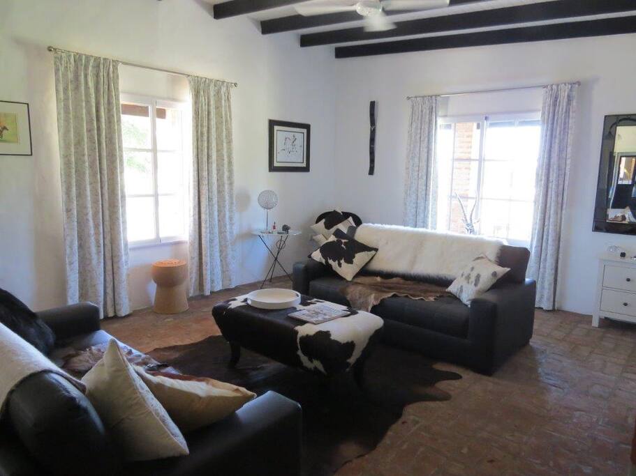 Guest Living Room with open fire place and flatscreen TV